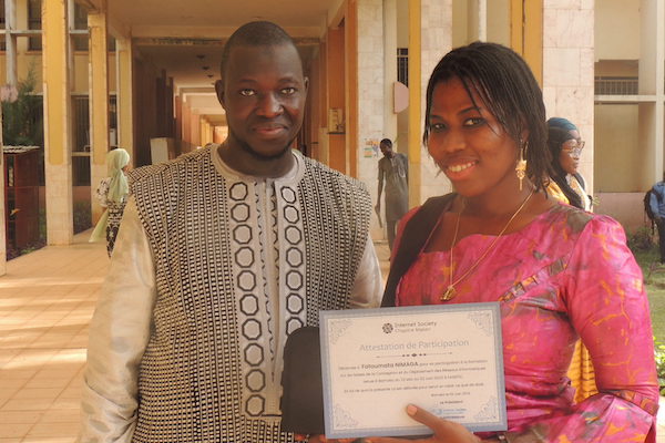 woman holding a certificate posing for a photo with a man